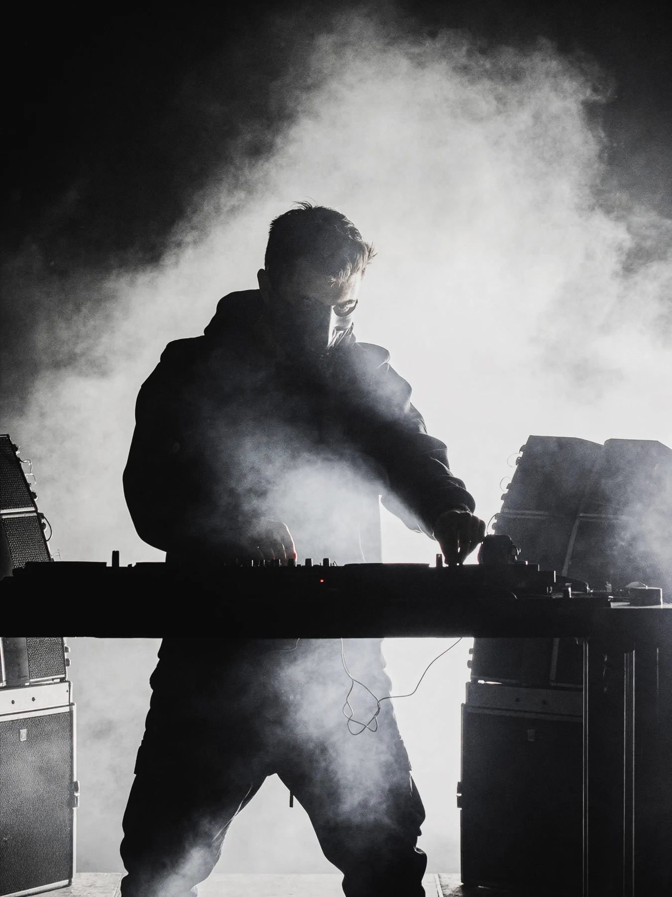 GR3GOR performing behind the decks in stage smoke